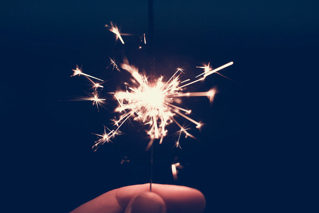 hand holding a sparkler firework